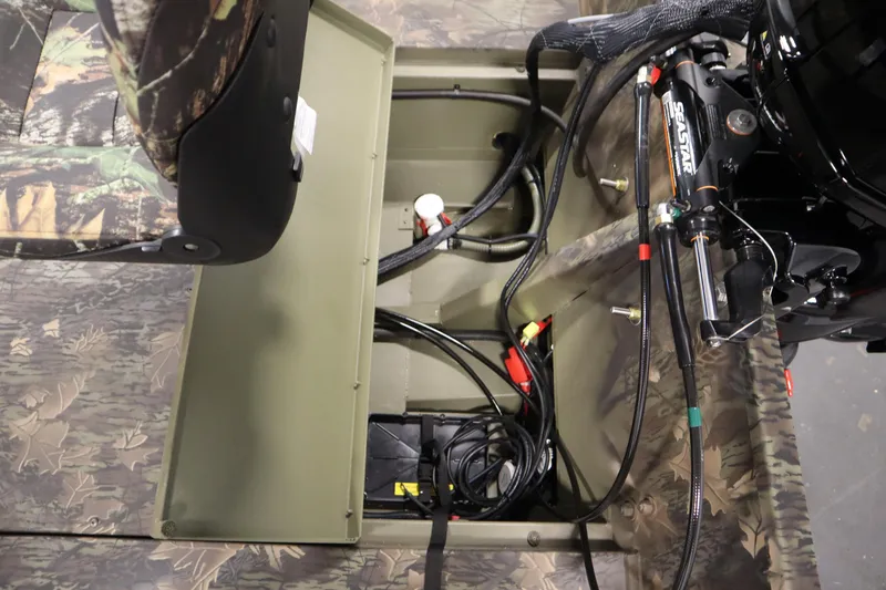 Slide: The Image of 2026 Lowe Roughneck RX1860 Pathfinder boat interior, showing camo seating and engine wiring. - 28