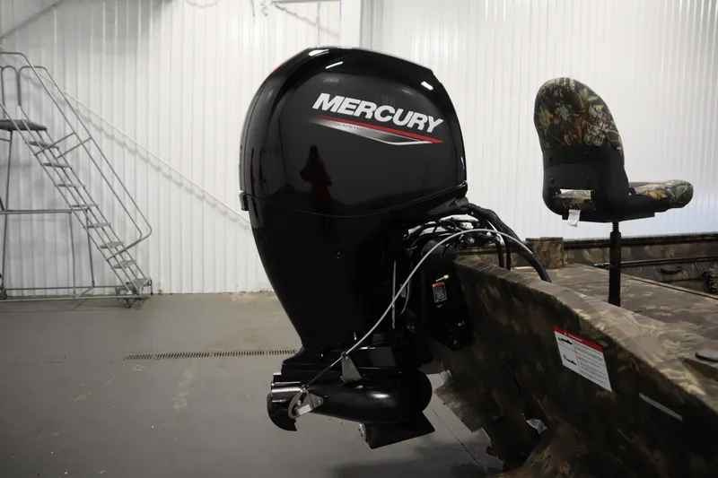 Slide: The Image of 2026 Lowe Roughneck RX1860 Pathfinder with Mercury outboard motor in a garage setting. - 30