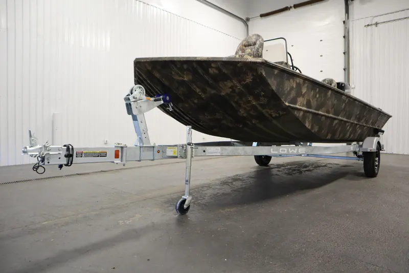 Slide: The Image of 2026 Lowe Roughneck RX1860 Pathfinder boat on trailer in indoor setting. - 33