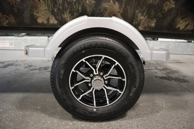 Slide: The Image of 2026 Lowe Roughneck RX1860 Pathfinder trailer wheel with black alloy rim and tire. - 34