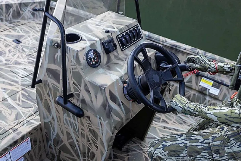 Slide: The Image of 2026 Lowe Roughneck RX1860 Pathfinder boat console with camouflage design and steering wheel. - 39