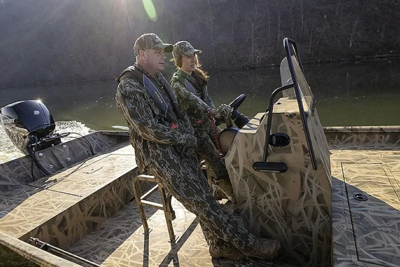 Slide: The Image of Two people in camouflage gear on a 2026 Lowe Roughneck RX1860 Pathfinder boat. - 41