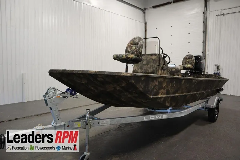 Slide: The Image of 2026 Lowe Roughneck RX1860 Pathfinder boat with camouflage design on a trailer in a showroom. - 42