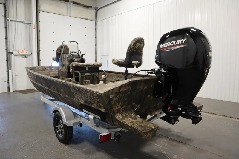 Slide: The Image of 2026 Lowe Roughneck RX1860 Pathfinder boat with Mercury engine in a garage. - 6