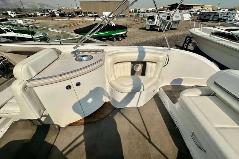 Slide: The Image of 2006 Cobalt 323 boat interior with white seating and a small sink area. - 11