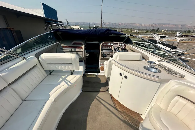 Slide: The Image of 2006 Cobalt 323 boat interior with white seating and control panel. - 12