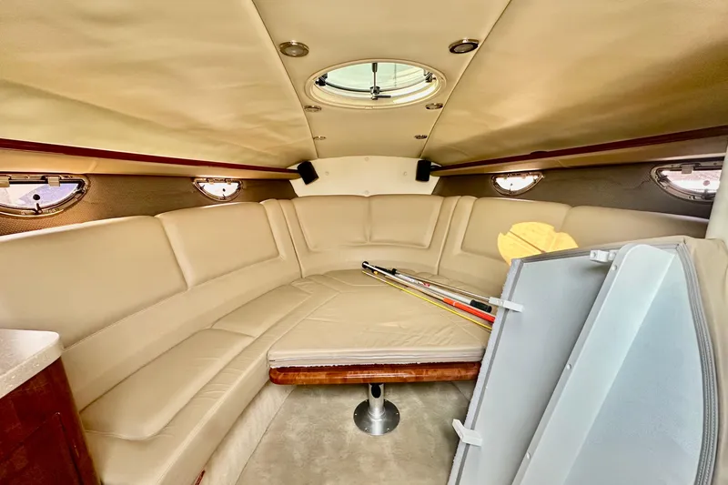 Slide: The Image of 2006 Cobalt 323 boat interior with beige seating and fishing rods. - 3