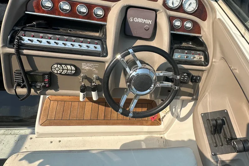 Slide: The Image of Dashboard of a 2006 Cobalt 323 boat with steering wheel and Garmin navigation system. - 4