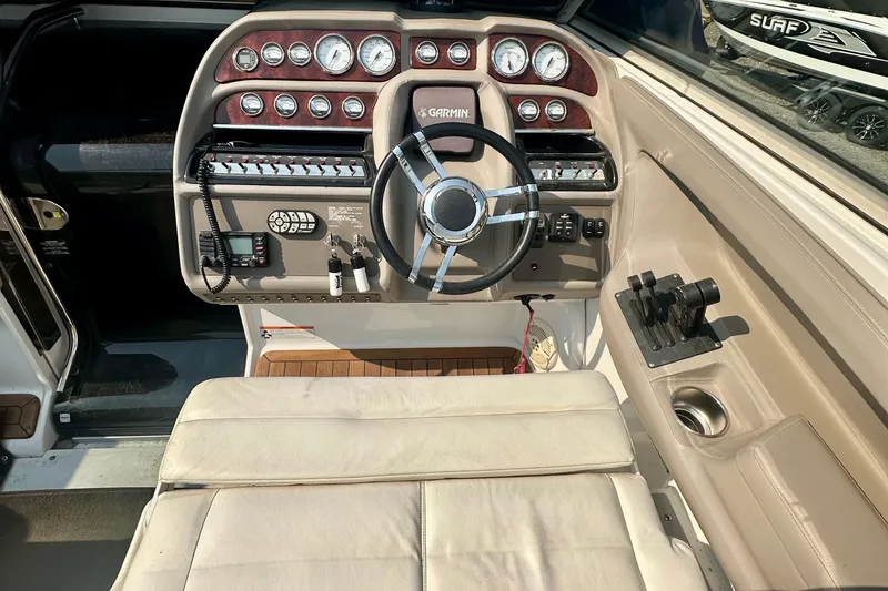 Slide: The Image of 2006 Cobalt 323 boat cockpit with steering wheel, gauges, and controls. - 6