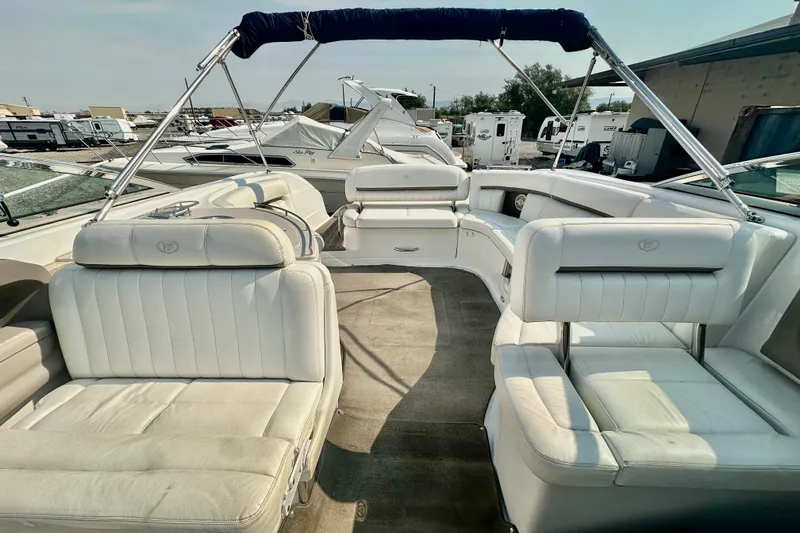 Slide: The Image of 2006 Cobalt 323 boat interior with white leather seating and open deck layout. - 7