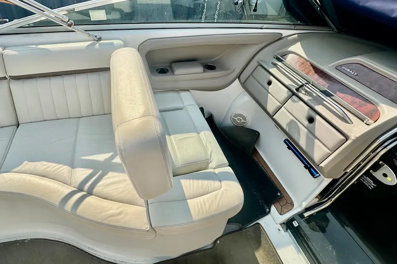 Slide: The Image of 2006 Cobalt 323 boat interior with beige leather seating and wood accents. - 8