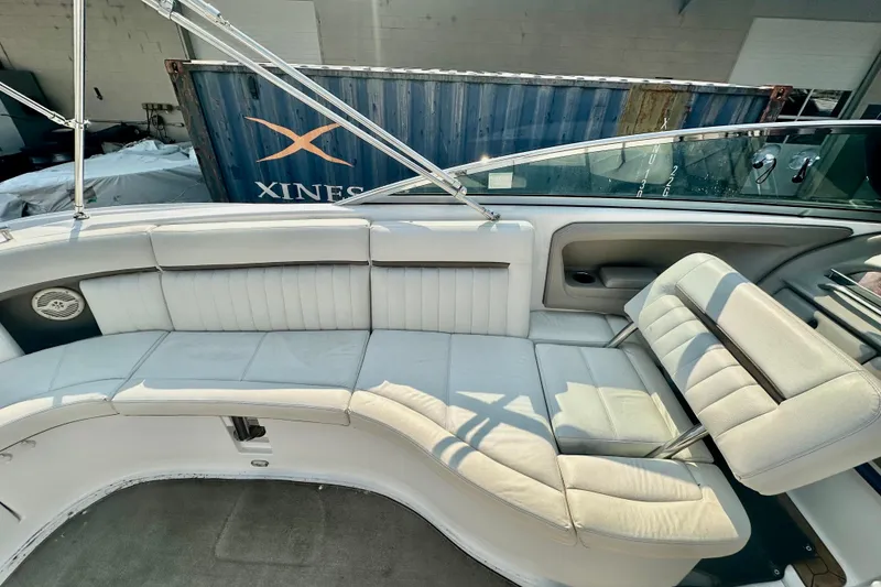 Slide: The Image of 2006 Cobalt 323 boat interior with white leather seating and stainless steel railings. - 9