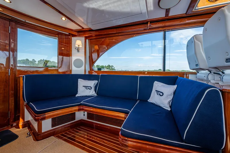 Slide: The Image of Luxurious interior of 2019 Hinckley T55 MKII Motor Yacht with blue seating and wooden accents. - 14