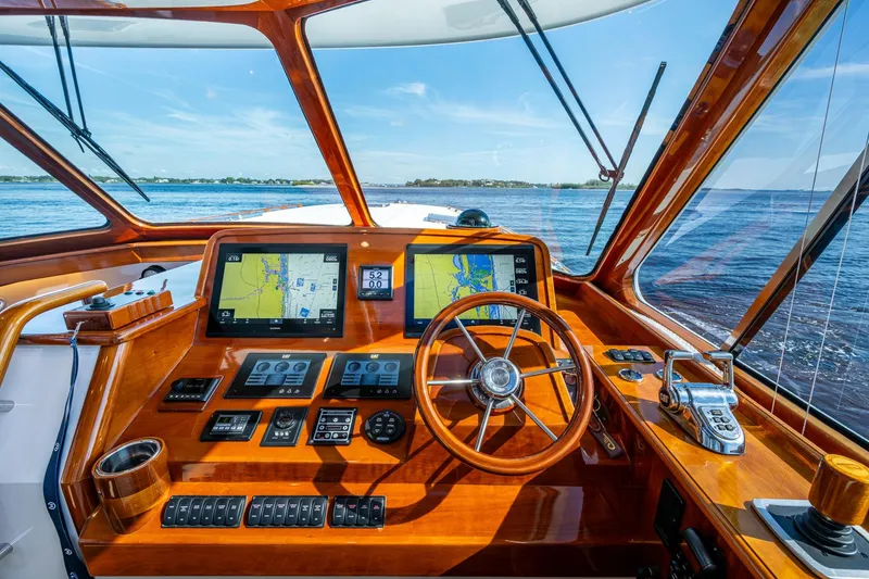 Slide: The Image of Helm of 2019 Hinckley T55 MKII Motor Yacht with navigation screens and wooden steering wheel. - 16