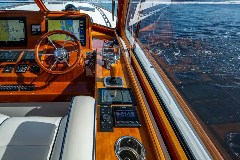Slide: The Image of Helm of 2019 Hinckley T55 MKII Motor Yacht with navigation screens and wooden steering wheel. - 17