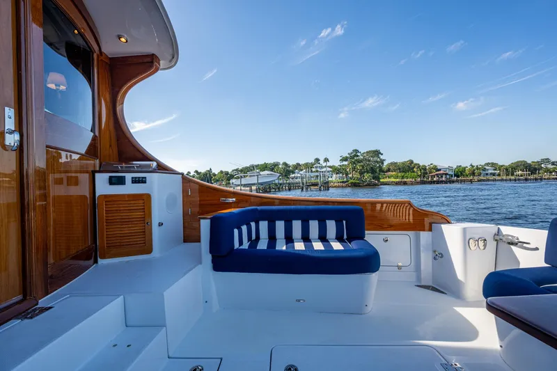 Slide: The Image of Luxurious 2019 Hinckley T55 MKII Motor Yacht deck with elegant seating and scenic water view. - 8