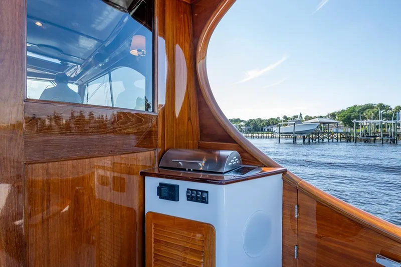 Slide: The Image of 2019 Hinckley T55 MKII Motor Yacht with sleek wooden interior and outdoor grill. - 9