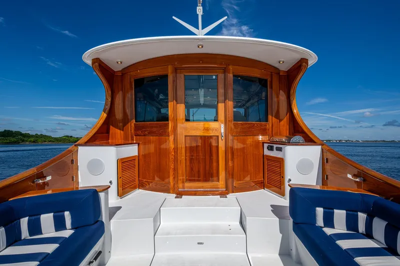 Slide: The Image of Luxurious 2019 Hinckley T55 MKII Motor Yacht with elegant wood finish and blue seating. - 10