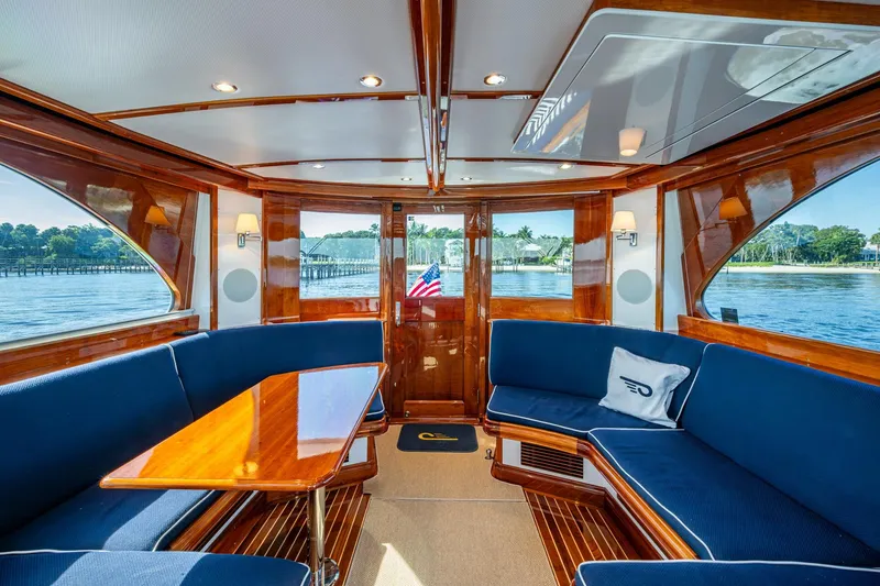 Slide: The Image of Luxurious interior of 2019 Hinckley T55 MKII Motor Yacht with elegant wood finish and blue seating. - 11