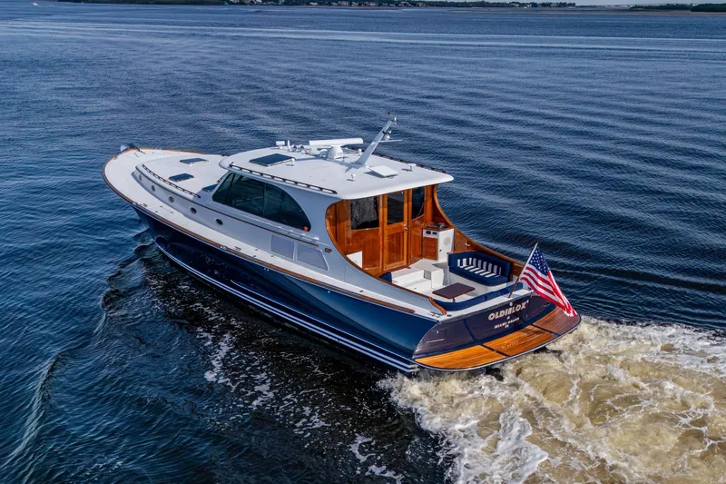 Slide: The Image of 2019 Hinckley T55 MKII Motor Yacht cruising on open water, rear view. - 2