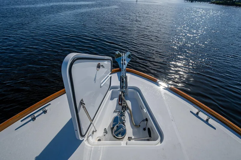 Slide: The Image of Hinckley T55 MKII Motor Yacht 2019 bow with open hatch, on calm water. - 46