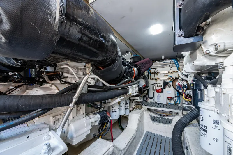 Slide: The Image of Engine room of 2019 Hinckley T55 MKII Motor Yacht, showcasing mechanical components. - 51