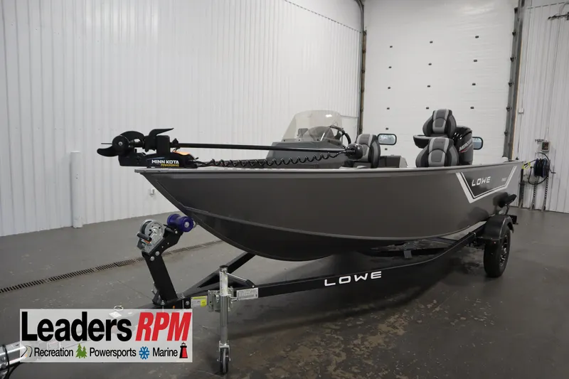 The Image of 2026 Lowe Fishing Machine 1625SC boat on trailer in indoor showroom. - 0