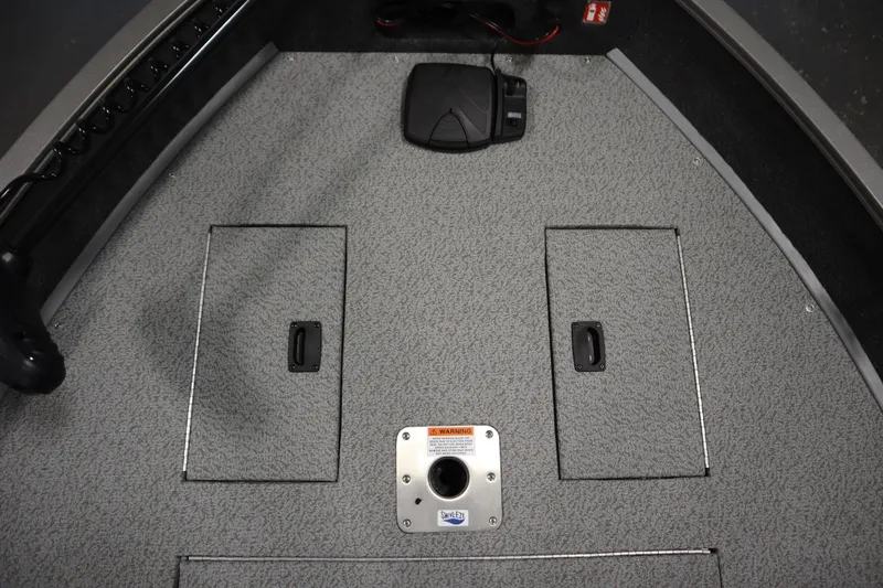 Slide: The Image of 2026 Lowe Fishing Machine 1625SC with Minn Kota PowerDrive motor in a garage. - 14