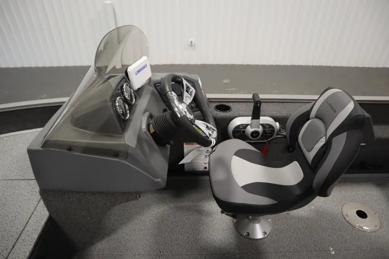 Slide: The Image of 2026 Lowe Fishing Machine 1625SC livewell with yellow lid and storage compartment. - 18