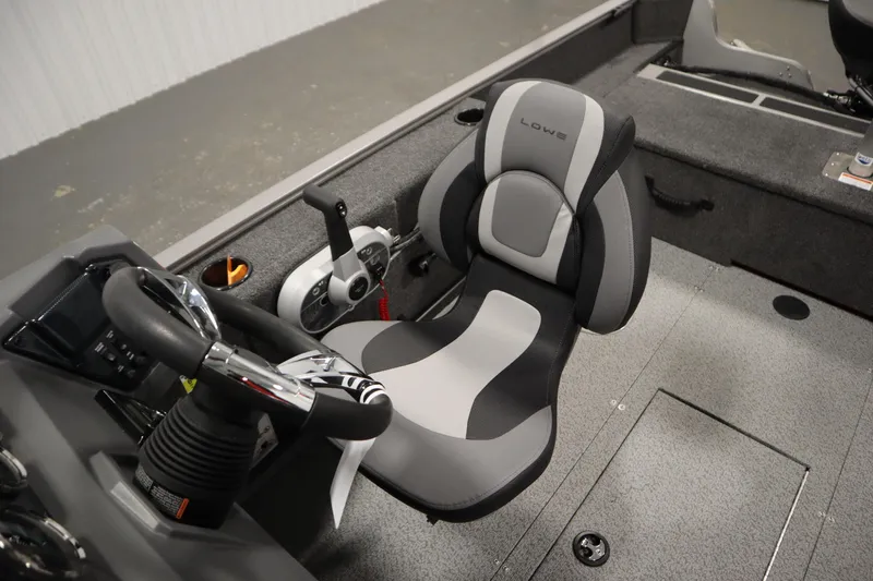 Slide: The Image of 2026 Lowe Fishing Machine 1625SC interior with steering wheel and comfortable seat. - 26
