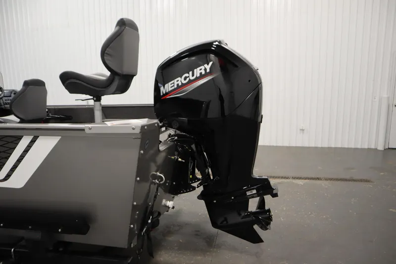 Slide: The Image of 2026 Lowe Fishing Machine 1625SC with Mercury outboard motor in a showroom. - 31