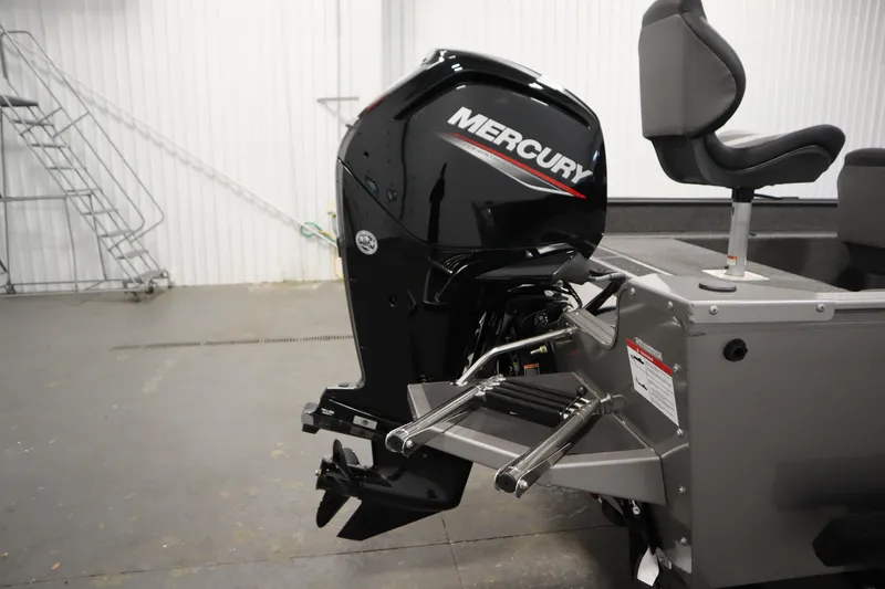 Slide: The Image of 2026 Lowe Fishing Machine 1625SC interior with open storage compartment between seats. - 32