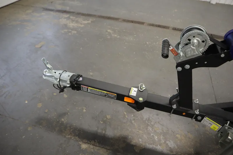 Slide: The Image of 2026 Lowe Fishing Machine 1625SC covered in a garage, on a trailer. - 34