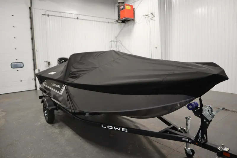 Slide: The Image of 2026 Lowe Fishing Machine 1625SC boat propeller close-up in a garage setting. - 37