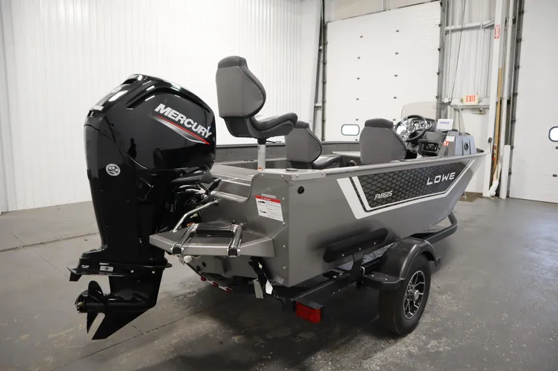 Slide: The Image of 2026 Lowe Fishing Machine 1625SC boat with Mercury engine in a garage setting. - 4