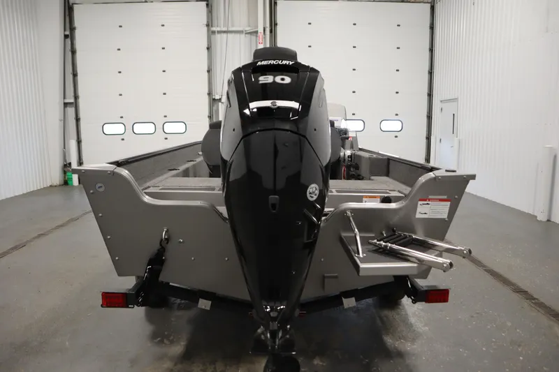 Slide: The Image of 2026 Lowe Fishing Machine 1625SC boat with Mercury engine on trailer in indoor setting. - 5