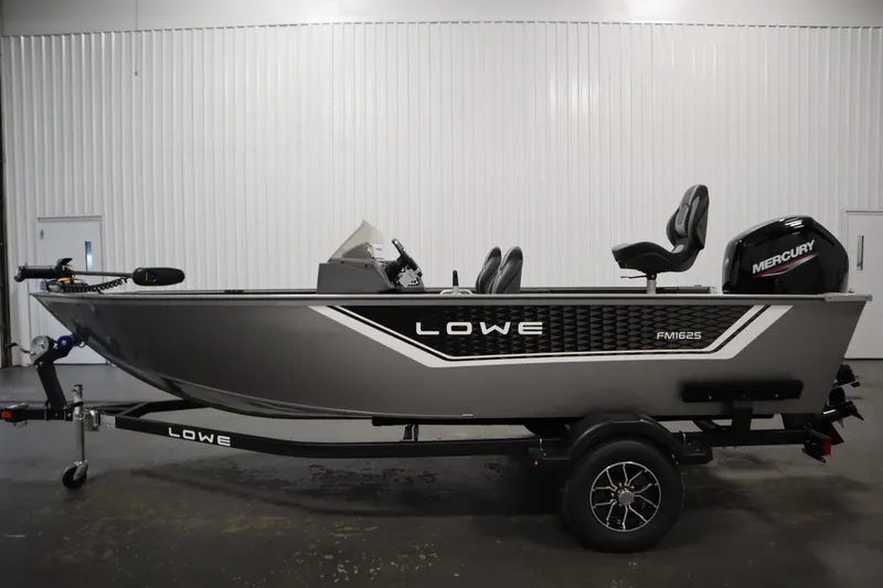 Slide: The Image of 2026 Lowe Fishing Machine 1625SC boat with Mercury engine in a garage setting. - 7