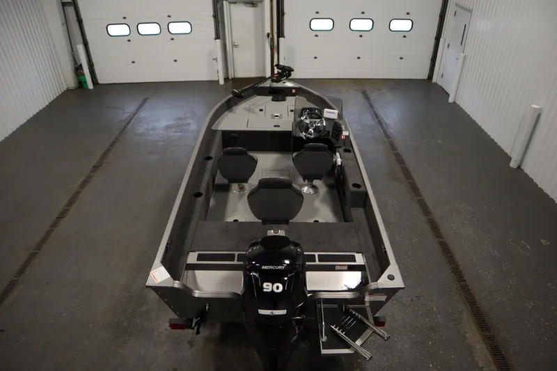 Slide: The Image of 2026 Lowe Fishing Machine 1625SC boat with Mercury engine in a garage setting. - 9