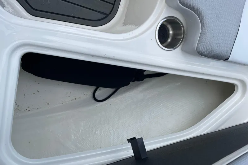 Slide: The Image of 2023 Bayliner VR5 boat storage compartment with cup holder and seating area. - 10