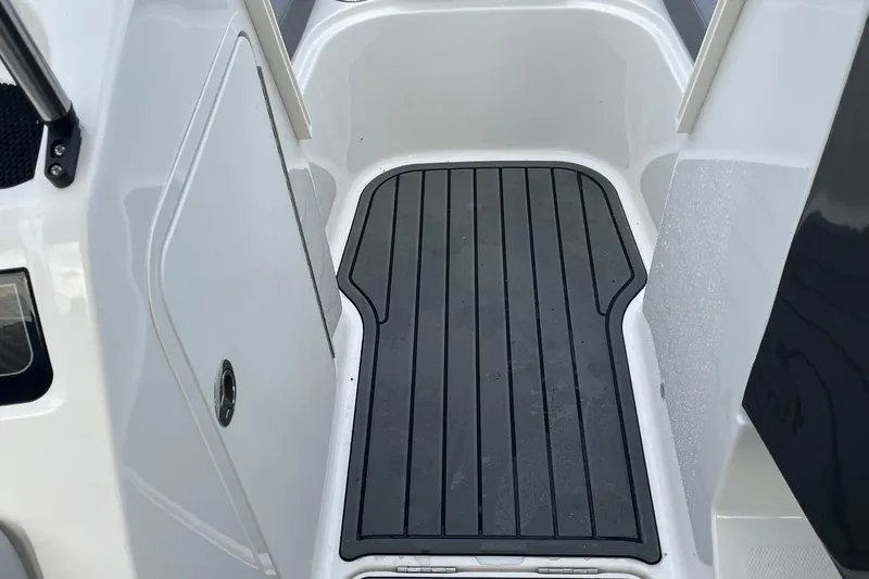 Slide: The Image of 2023 Bayliner VR5 boat interior with non-slip flooring and storage compartment. - 11