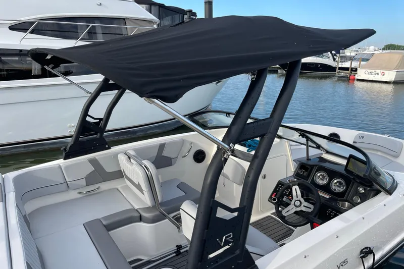 Slide: The Image of 2023 Bayliner VR5 boat with black canopy, docked at marina. - 23