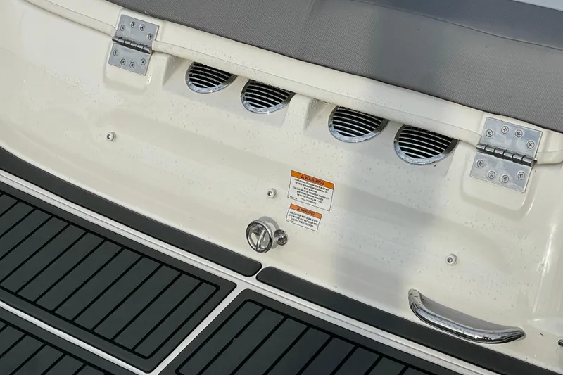 Slide: The Image of 2023 Bayliner VR5 boat stern with ventilation grilles and warning labels. - 25