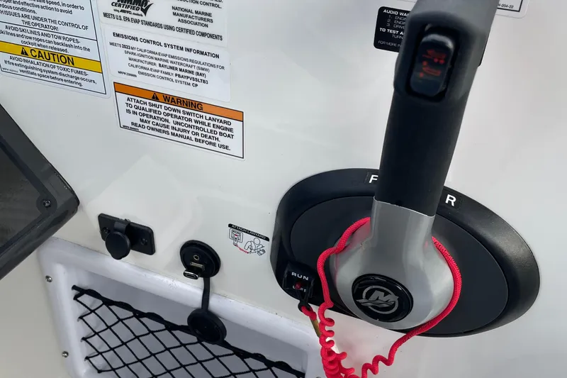 Slide: The Image of 2023 Bayliner VR5 boat control panel with throttle and safety warnings. - 7