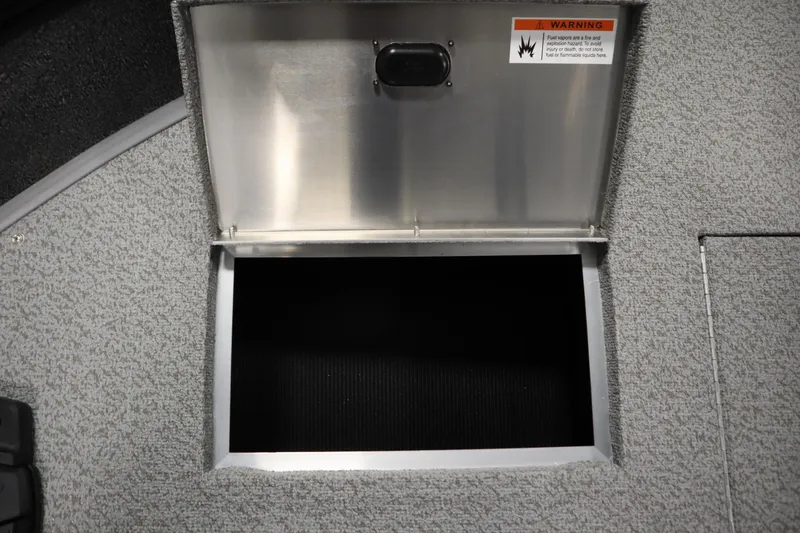 Slide: The Image of 2026 Lowe Fishing Machine 1625WT storage compartment with open lid and warning label. - 16