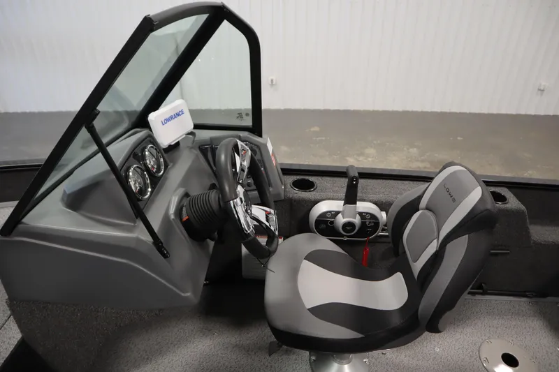 Slide: The Image of 2026 Lowe Fishing Machine 1625WT interior with steering wheel and seat. - 19