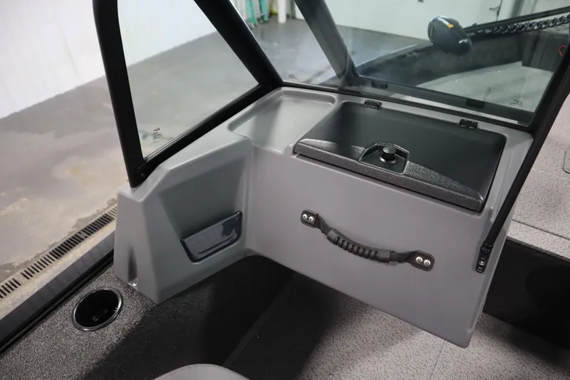 Slide: The Image of 2026 Lowe Fishing Machine 1625WT interior with storage compartment and windshield. - 30