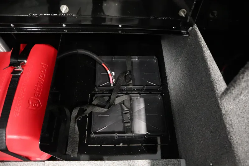 Slide: The Image of 2026 Lowe Fishing Machine 1625WT battery compartment with red fuel tank and wiring. - 36