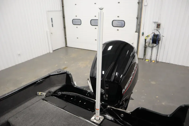 Slide: The Image of 2026 Lowe Fishing Machine 1625WT with Mercury outboard motor in a garage. - 37