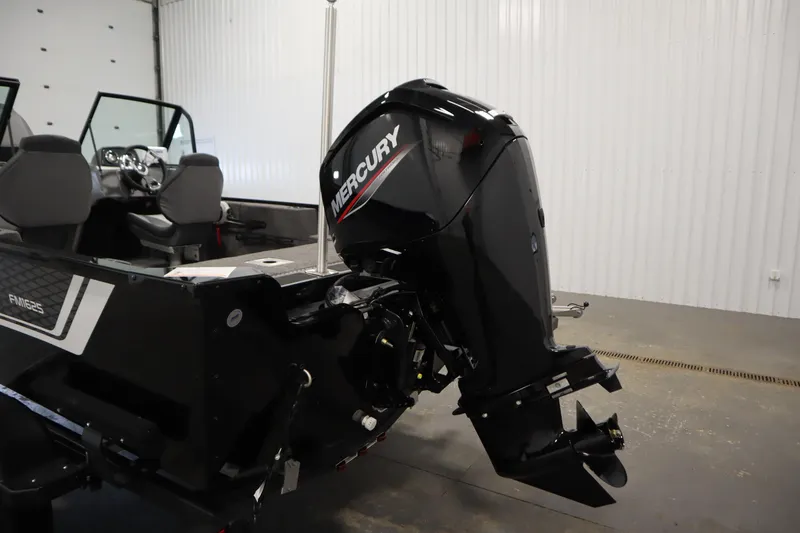 Slide: The Image of 2026 Lowe Fishing Machine 1625WT with Mercury outboard motor in a garage setting. - 39