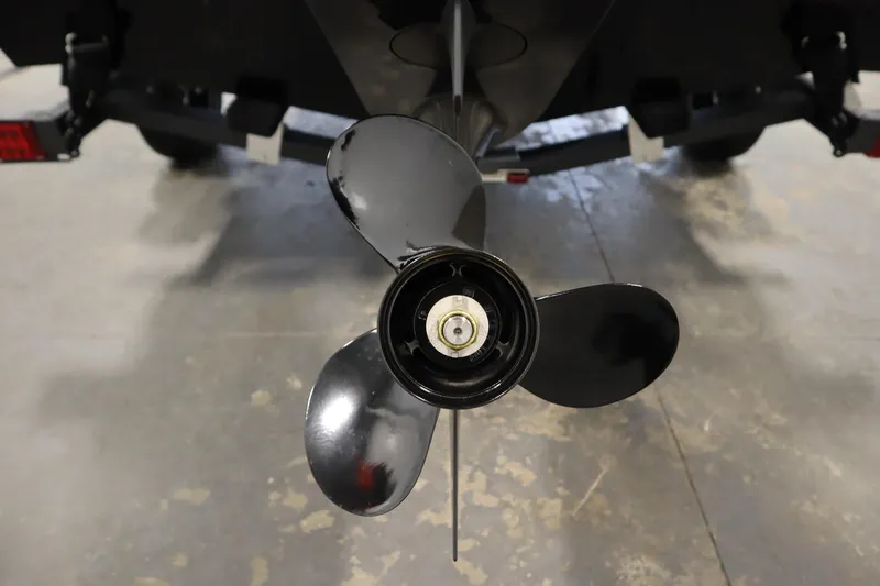 Slide: The Image of 2026 Lowe Fishing Machine 1625WT boat propeller, close-up view in a garage setting. - 42